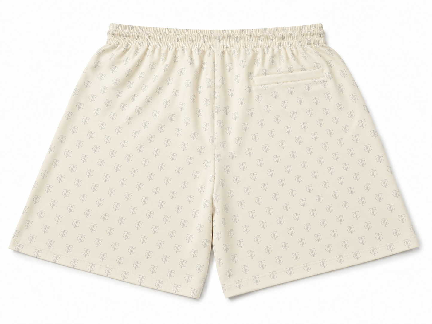 A pair of cream-colored shorts with a repeating light gray anchor pattern, featuring an elastic waistband and a side pocket, shown against a plain white background.