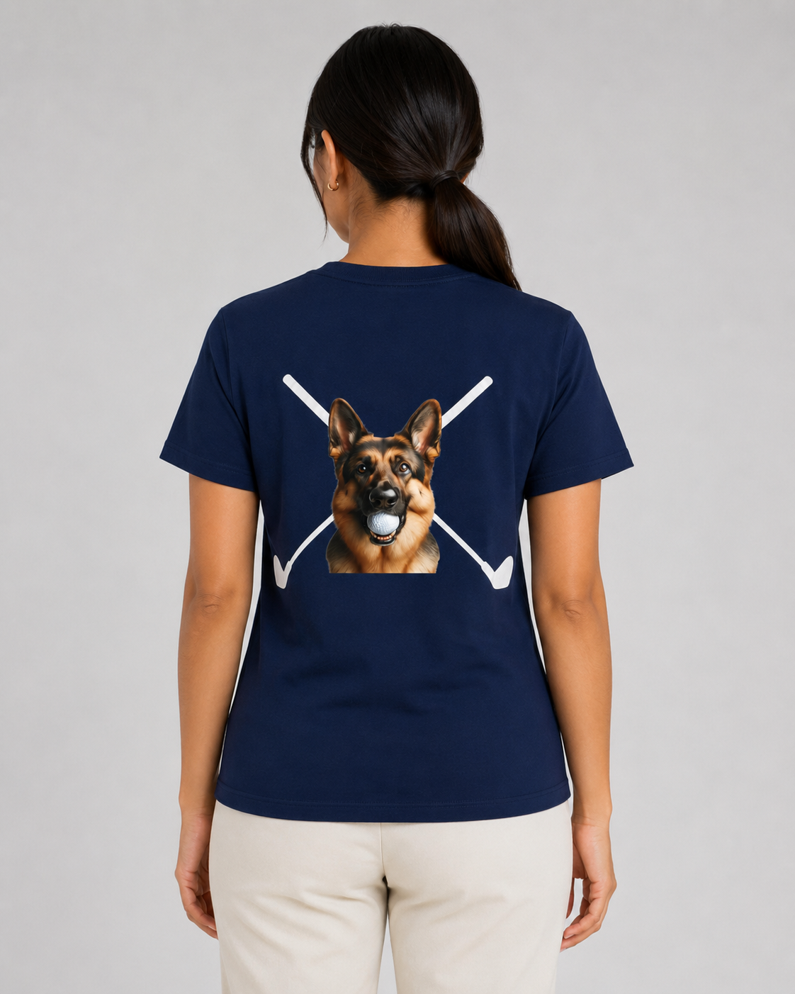 Person wearing a navy blue t-shirt with a dog graphic on the back, standing against a gray background