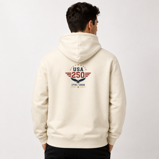 Male model wearing a vintage cream USA 250 fleece hoodie with a centered USA 250 eagle emblem and 1776–2026 back graphic.