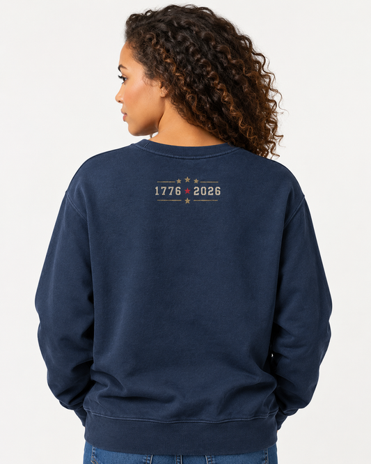 Vintage navy heavyweight USA 250 crewneck sweatshirt with a small upper-back 1776 • 2026 commemorative graphic and gold stars.
