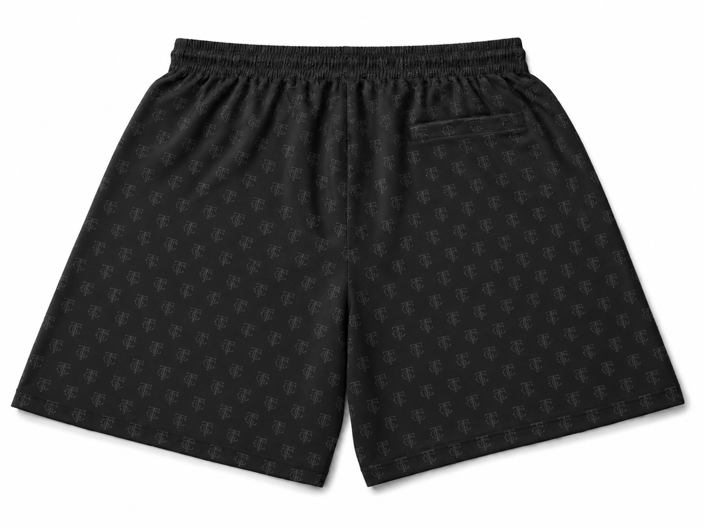 Black athletic shorts with an all-over tonal monogram pattern, featuring an elastic waistband and a side pocket, shown against a plain white background.