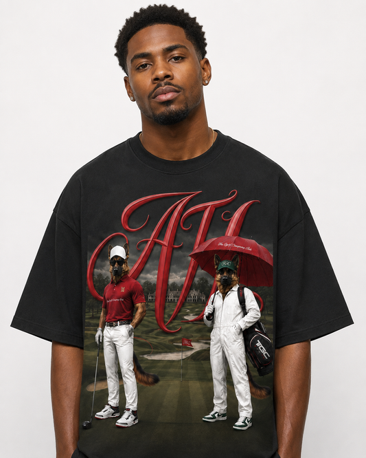 Black oversized ATL Hudson Championship DTG tee featuring two Hudson golfer characters, red ATL script artwork, and golf course background.