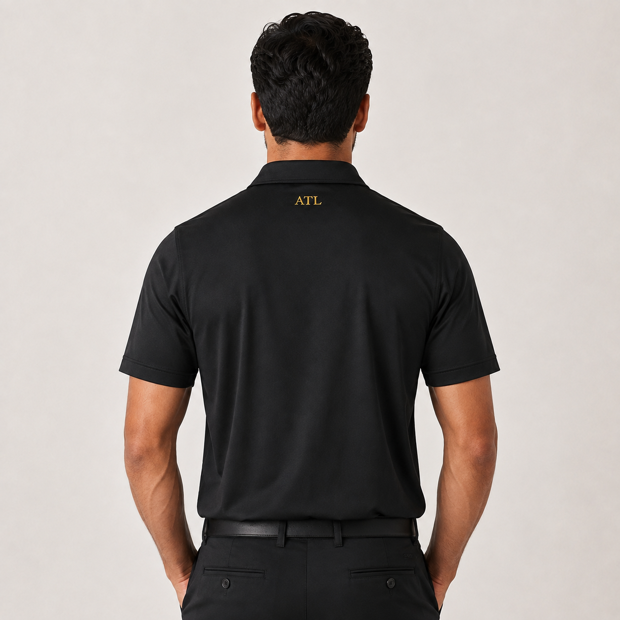 Black ATL Championship Performance Polo front view with gold TGC monogram.
