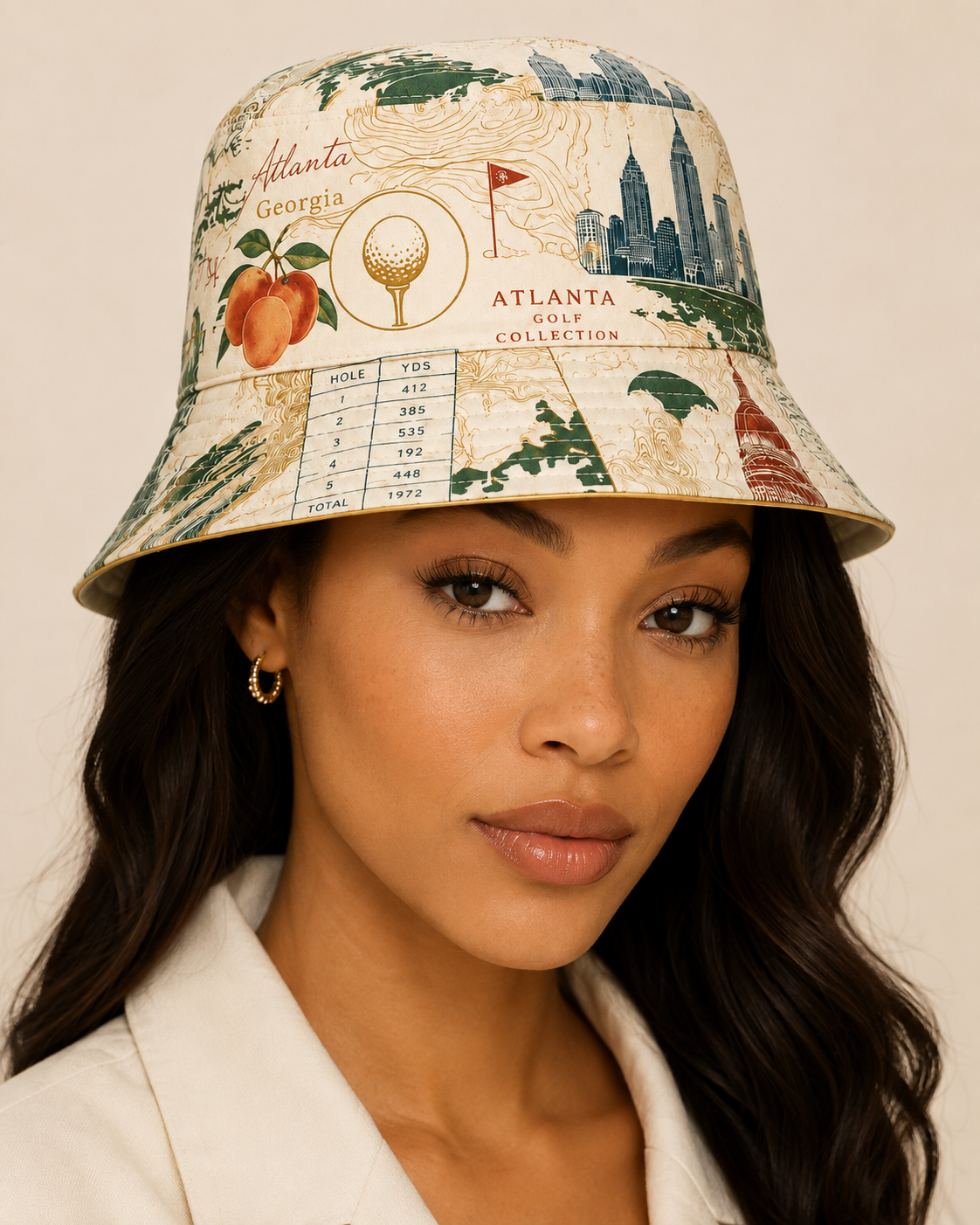A woman wearing a bucket hat with an Atlanta golf course and cityscape print, featuring text like 'Atlanta Georgia' and 'Atlanta Golf Collection'.