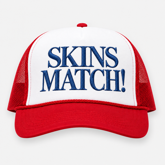 SKINS MATCH USA Red trucker golf hat with navy embroidery and white front panel.