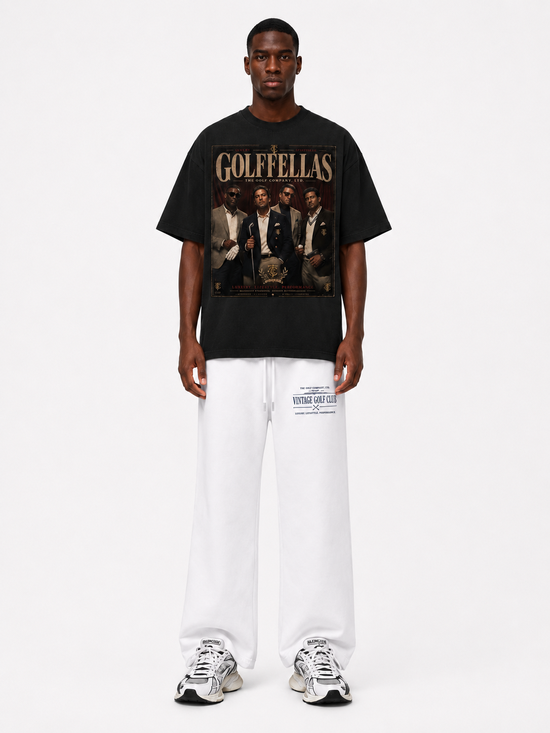 Male model wearing Black Golffellas Vintage Tee with white Vintage Golf Club sweatpants