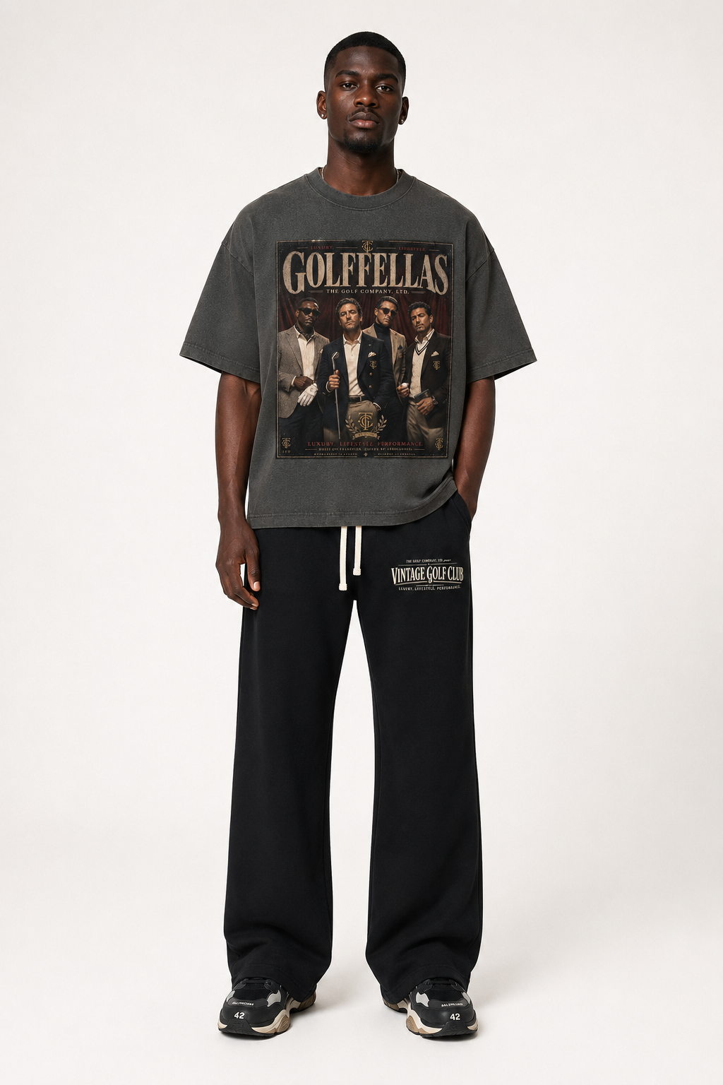 Male model wearing Washed Charcoal Golffellas Vintage Tee with black Vintage Golf Club sweatpants