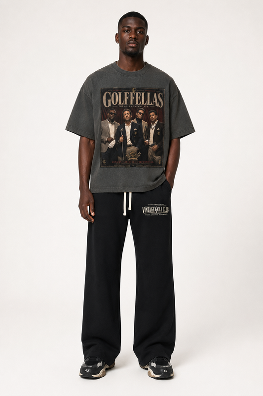 Male model wearing Washed Charcoal Golffellas Vintage Tee with black Vintage Golf Club sweatpants
