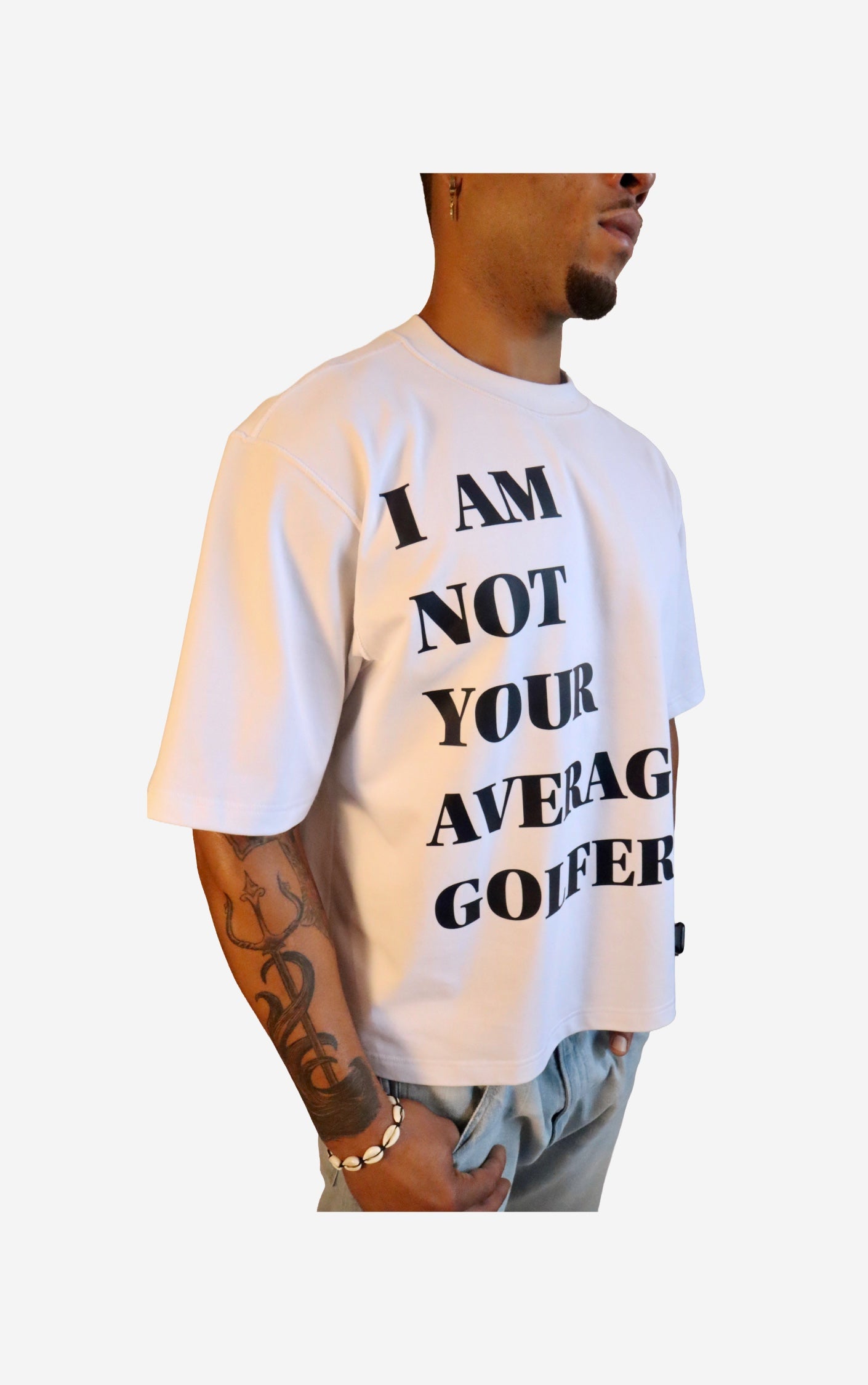 Model wearing a white t-shirt with text 'I AM NOT YOUR AVERAGE GOY' on a plain background