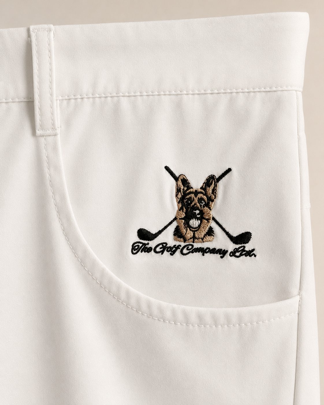Embroidered logo on a white pocket with 'The Golf Company Ltd.' text.