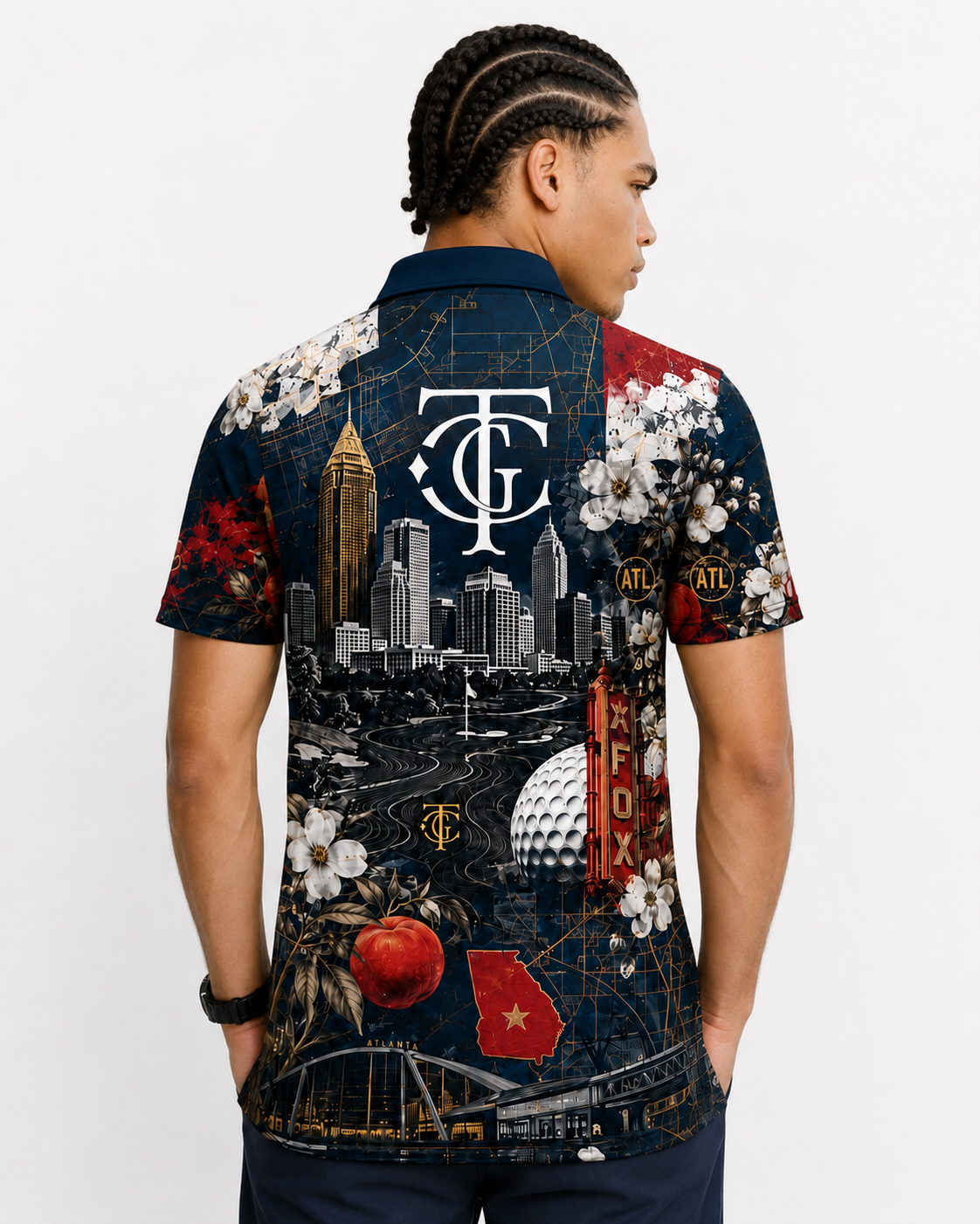 A man wearing a short-sleeve button-up shirt with a complex graphic print featuring the Tampa Bay Buccaneers logo, city skyline, sports elements, and floral details, shown from the back against a white studio background.