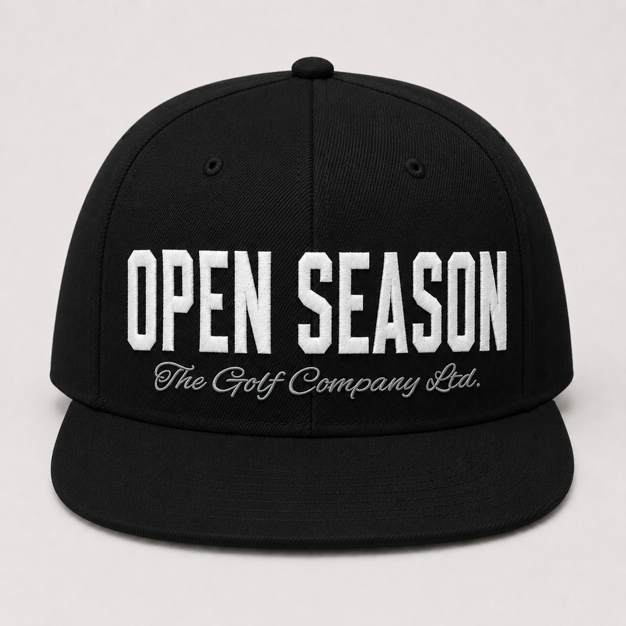 Black cap with 'Open Season The Golf Company Ltd.' text on a white background