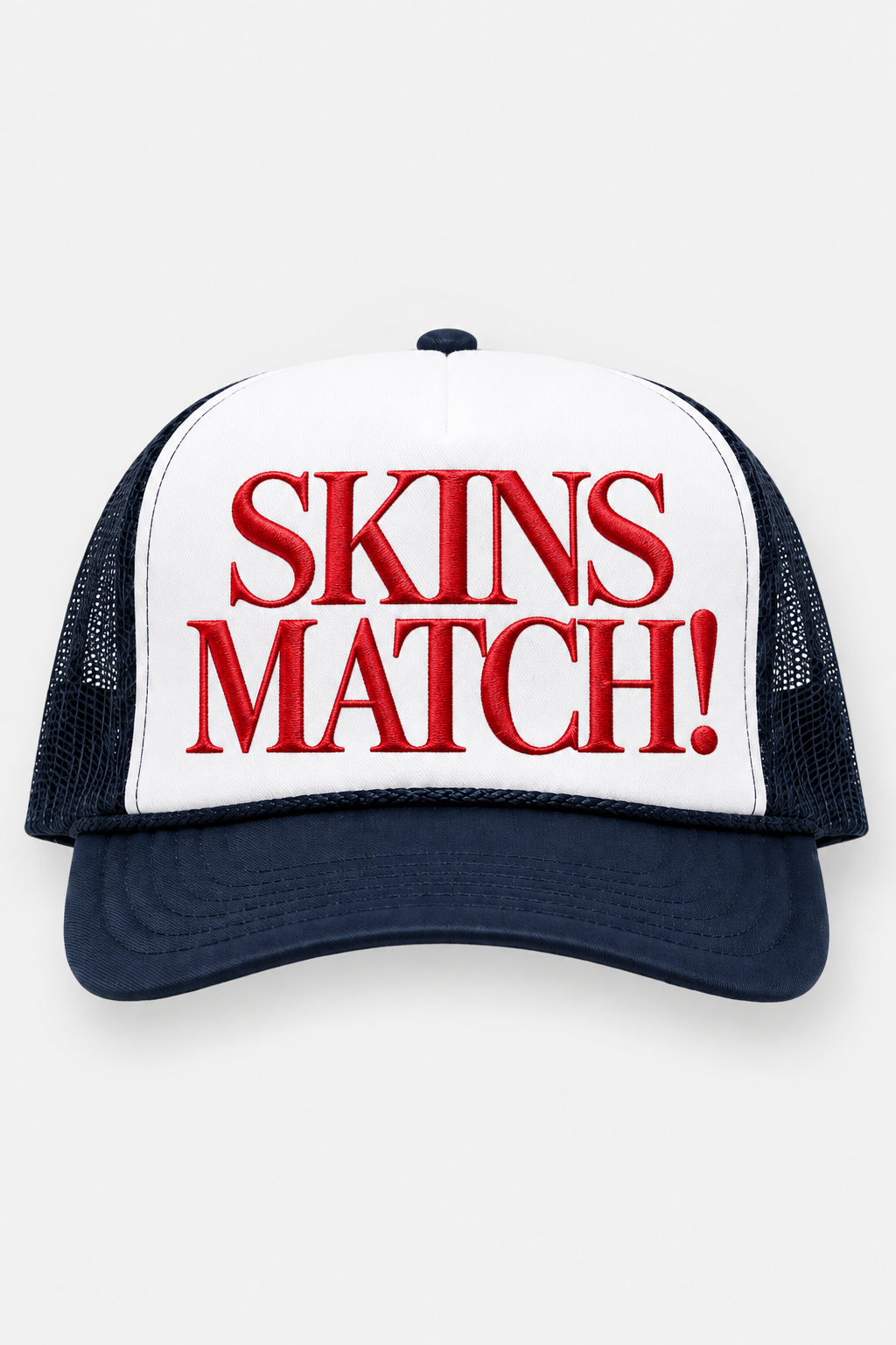 Front product view of the SKINS MATCH! USA Navy Trucker Hat featuring a white front panel, navy brim and mesh, and bold red embroidered SKINS MATCH! lettering.