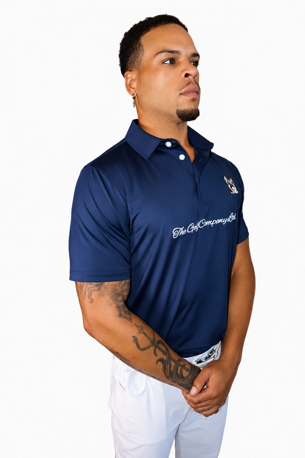 Male model wearing navy Men’s Signature Performance Golf Shirt with white golf pants.