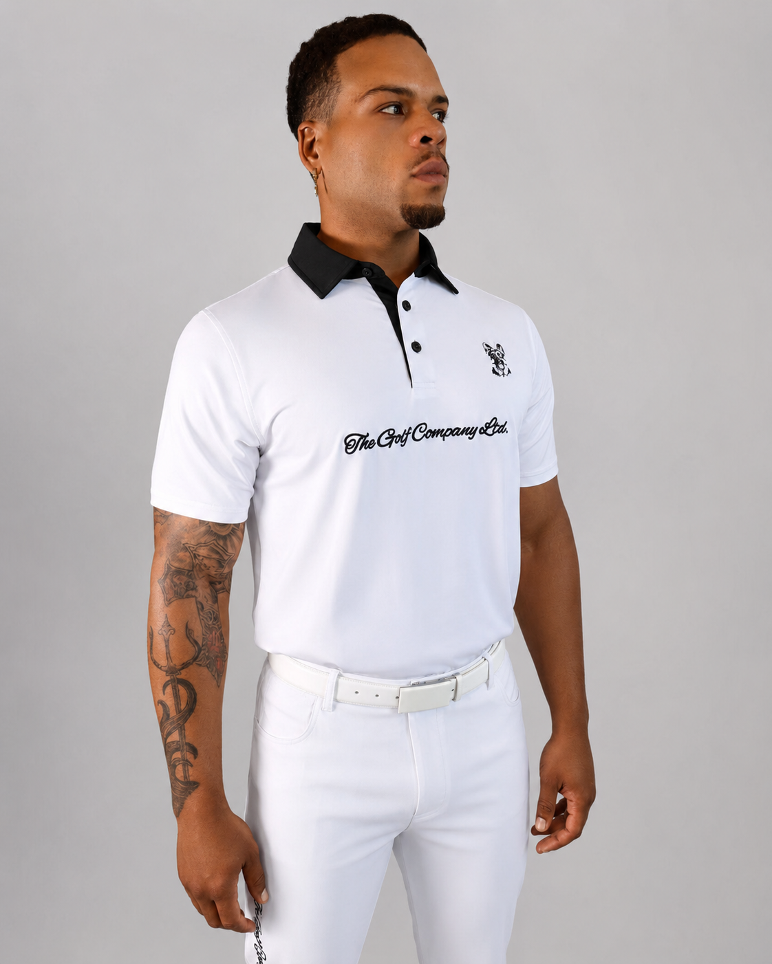 Male model wearing white Men’s Signature Performance Golf Shirt with black collar and white golf pants.