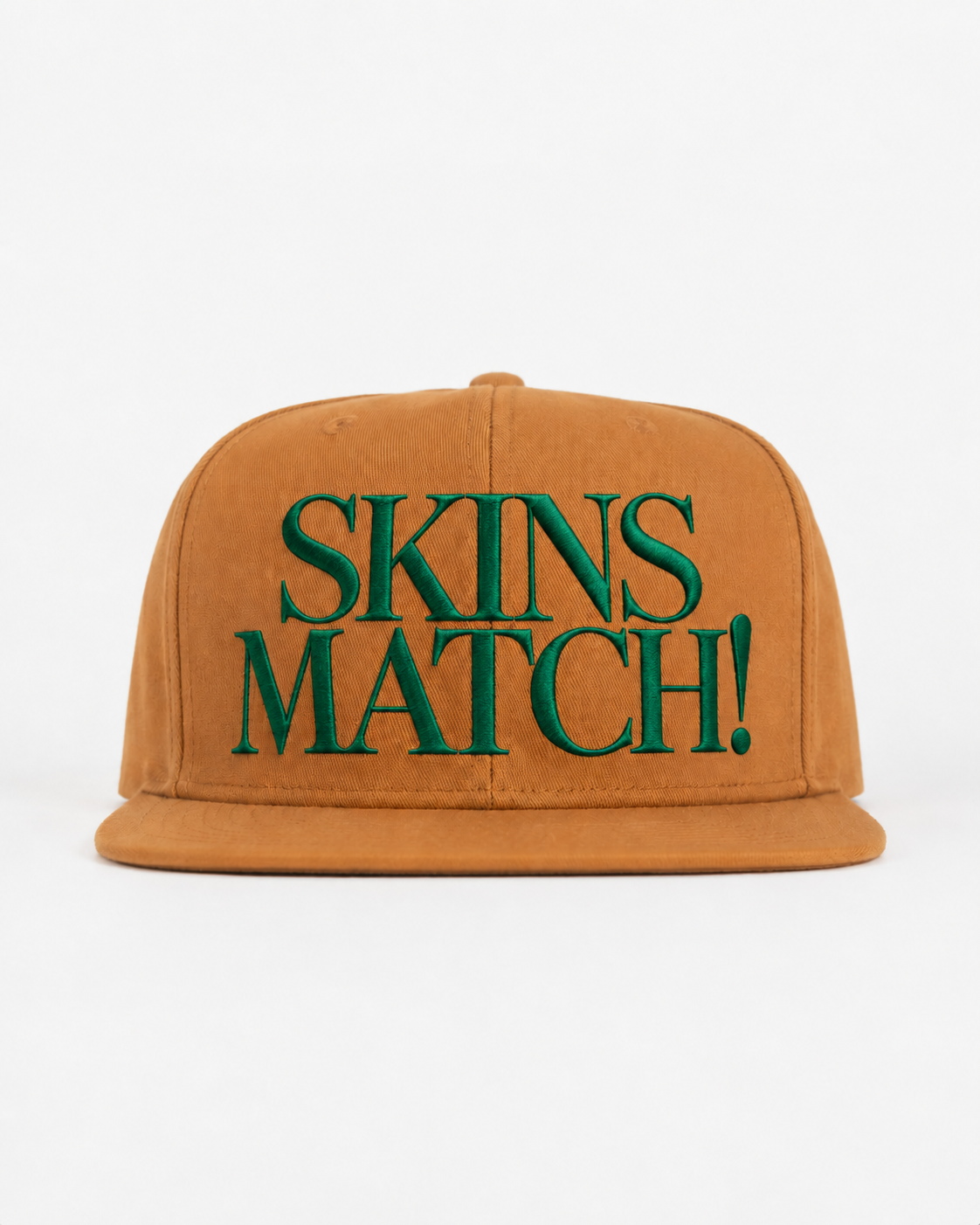 SKINS MATCH Heritage Tan golf hat with green embroidered lettering by The Golf Company Ltd.
