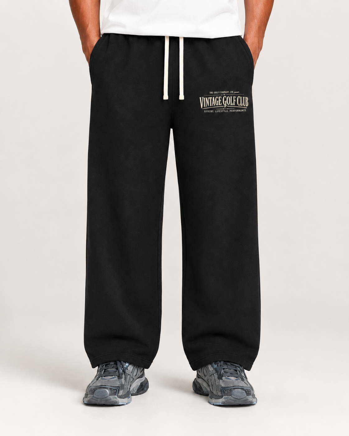 Black Vintage Golf Club weathered sweatpants on male model with cream drawstrings and grey sneakers.