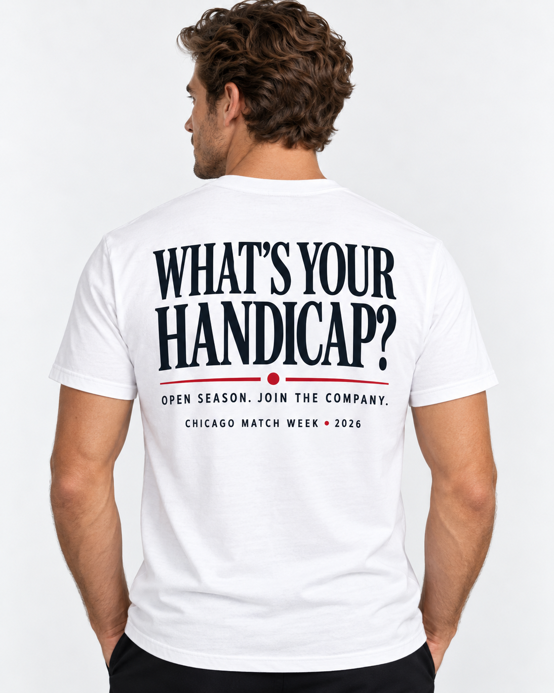 A man viewed from behind wearing a white t-shirt with a bold black and red graphic on the back that reads 'WHAT'S YOUR HANDICAP?'.