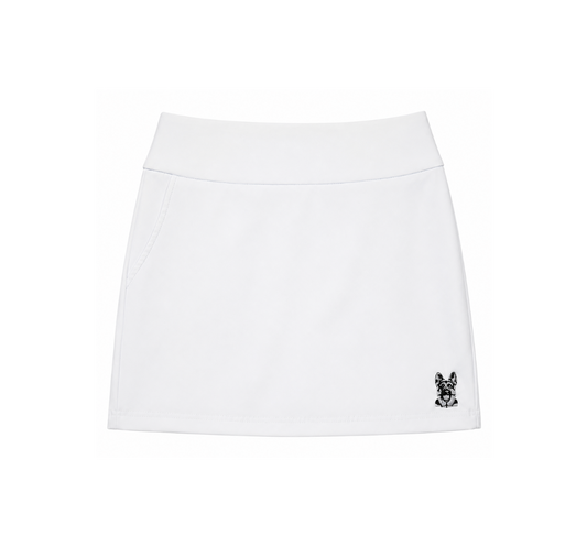Women’s white performance golf skort front view with embroidered dog logo by The Golf Company Ltd.