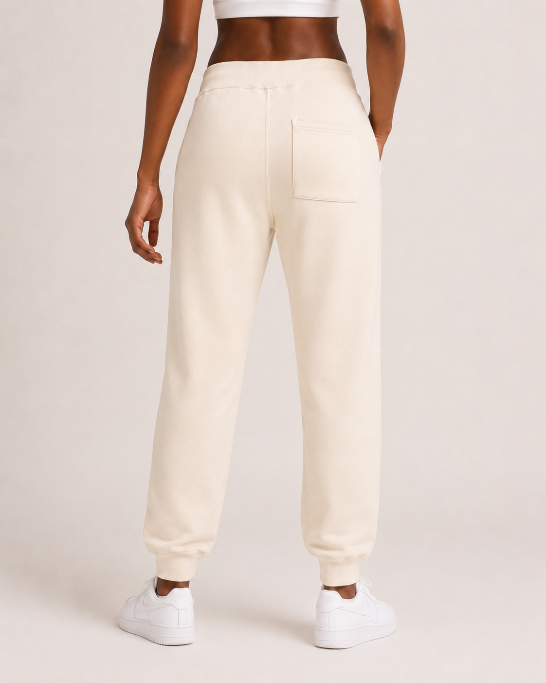 Women’s sandshell premium fleece jogger rear view with back pocket, ribbed cuffs, and soft 3-end fleece construction w/model.