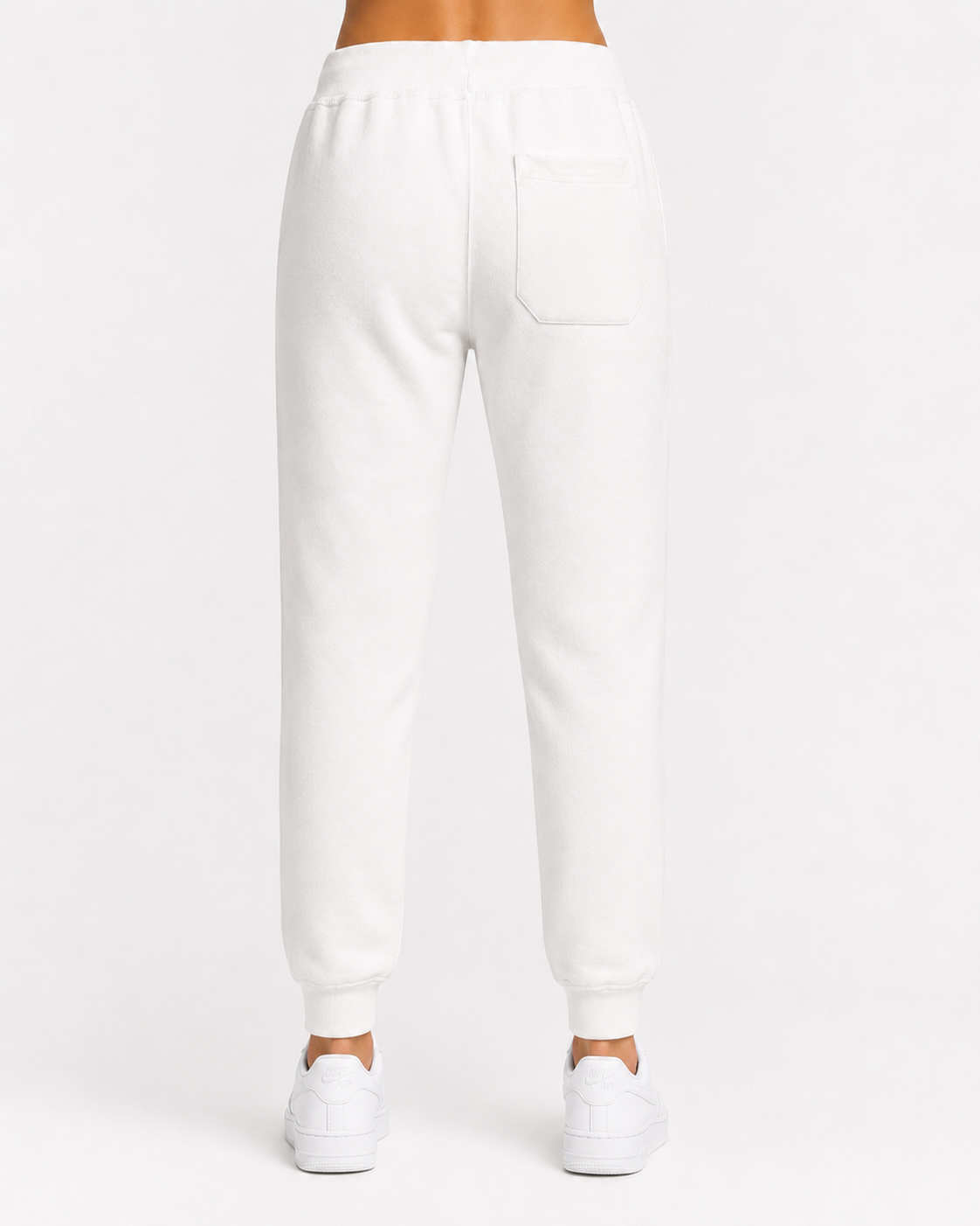 Women’s white premium fleece jogger rear view with back pocket, ribbed cuffs, and soft 3-end fleece construction w/model.