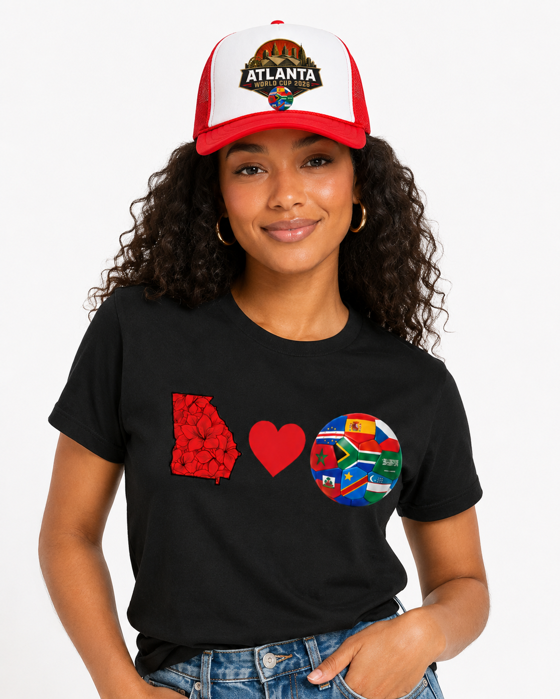 Female model wearing a red Atlanta 2026 skyline trucker cap with matching Georgia soccer tee.
