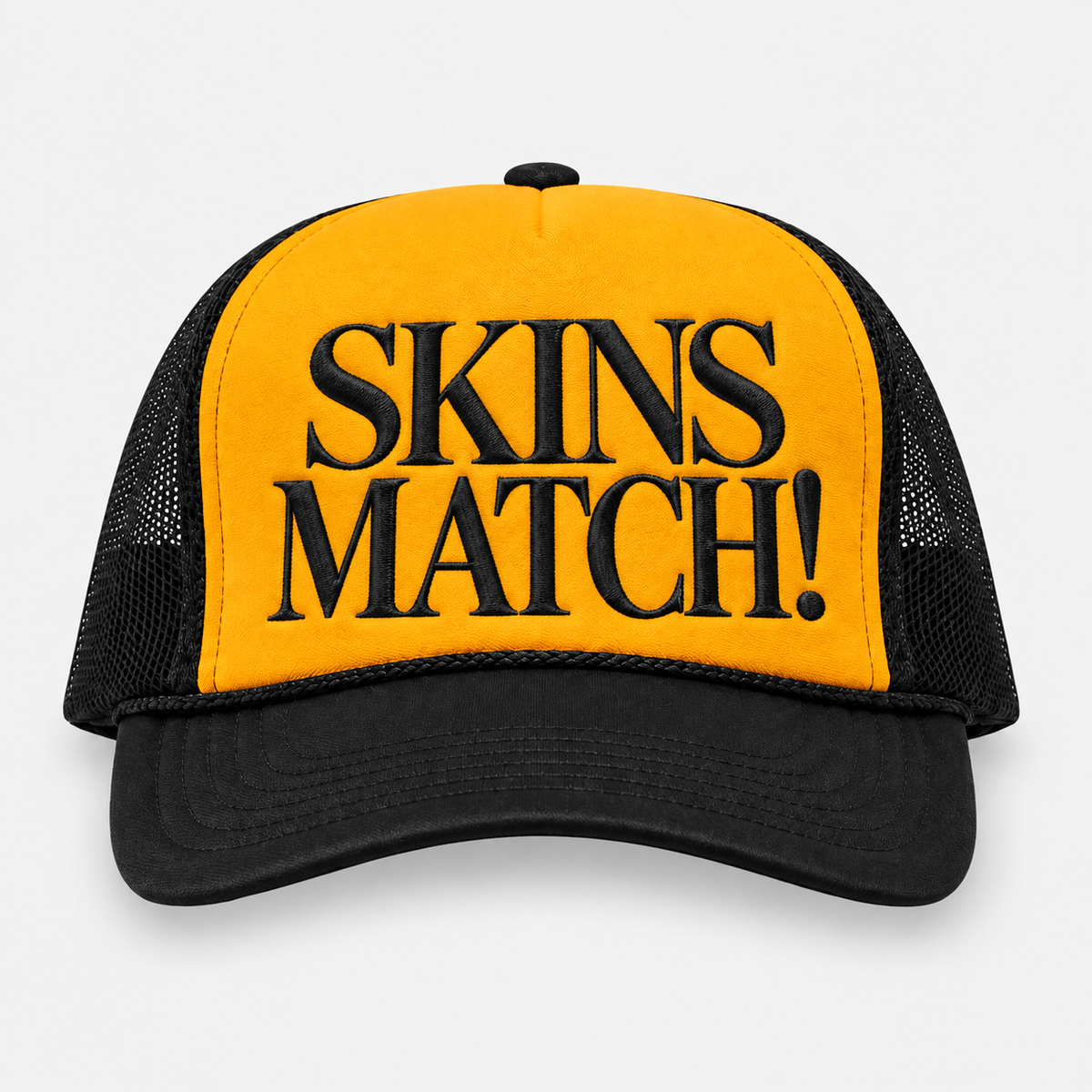 SKINS MATCH gold and black trucker golf hat with black embroidered lettering.